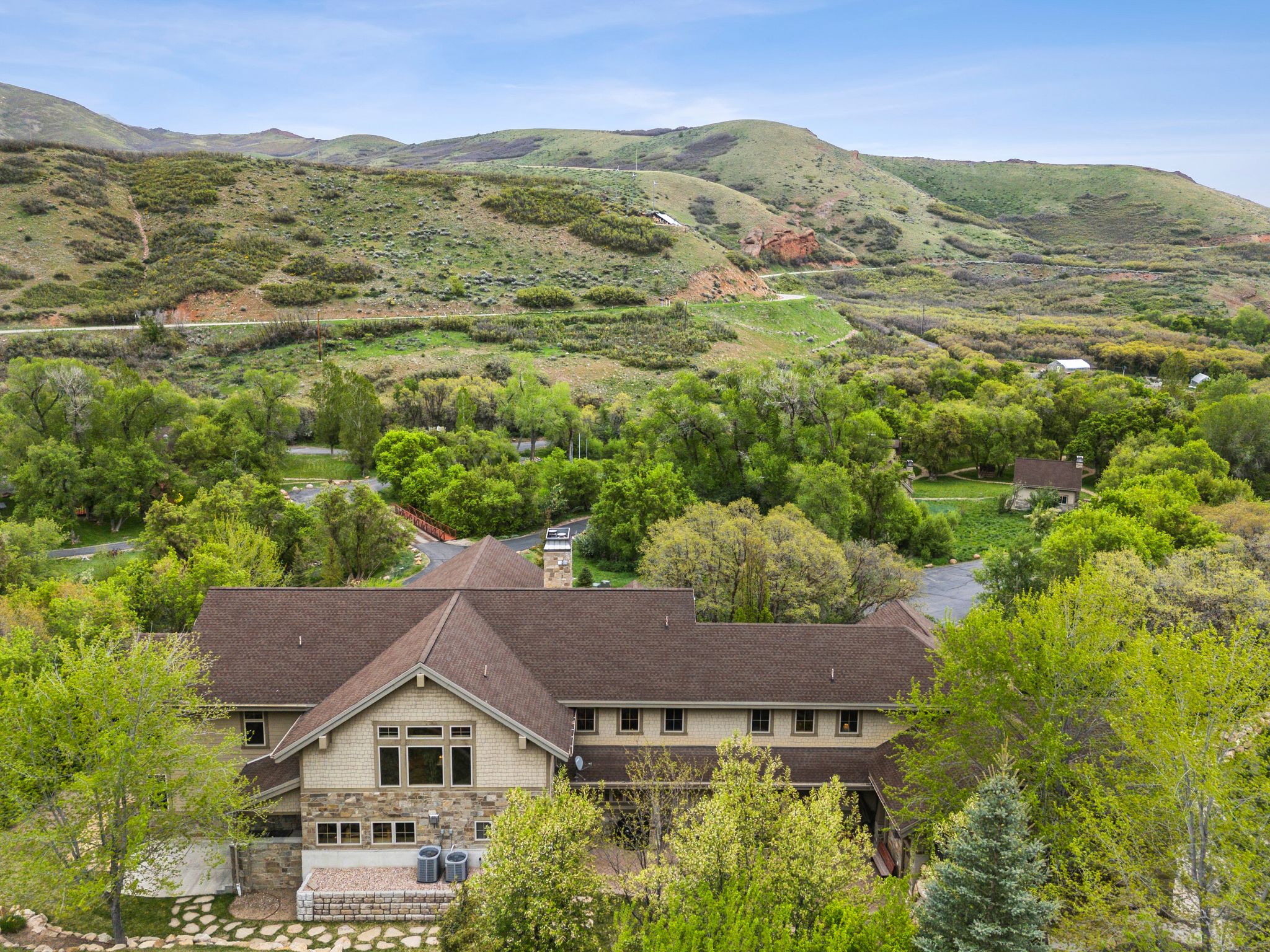Aerial view of property and surrounding area with a mountainous background