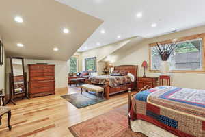 Bedroom featuring multiple windows, light wood-type flooring, and recessed lighting