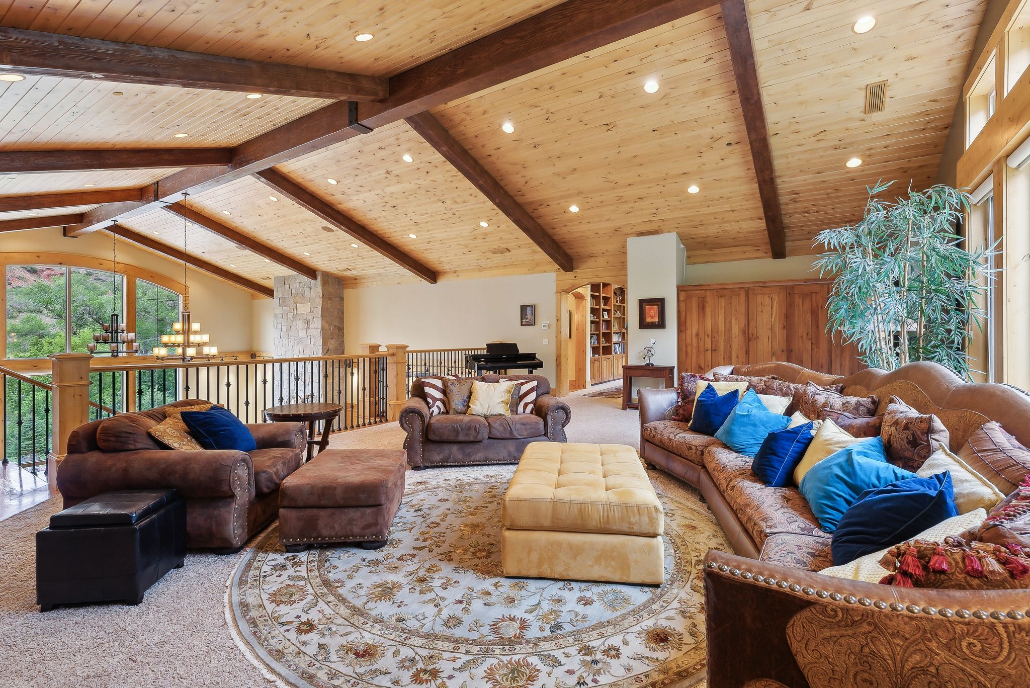 Carpeted living area with wooden ceiling, a chandelier, and recessed lighting