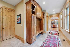 Mudroom featuring baseboards and recessed lighting