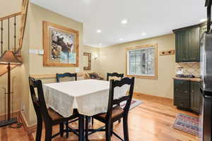 Dining area with light wood-style flooring, recessed lighting, and baseboards