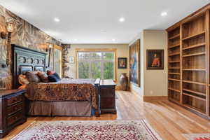 Bedroom with recessed lighting, light wood-style flooring, and baseboards