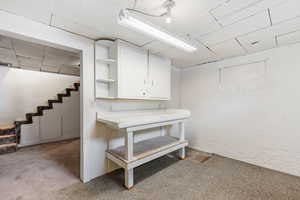Finished below grade area with light carpet and stairway