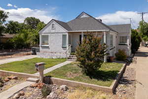View of front facade featuring brick siding and board and batten siding