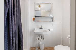 Bathroom featuring toilet and tile patterned flooring
