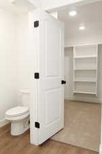 View of toilet room/large primary closet