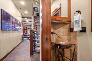 Wine area with stone finish floors and recessed lighting