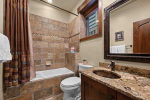 Full bath with tiled shower / bath combo and vanity