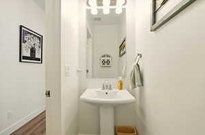 Bathroom featuring wood finished floors and baseboards