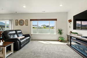 Living area with carpet flooring and recessed lighting