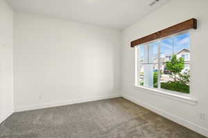 Empty room with carpet flooring and baseboards
