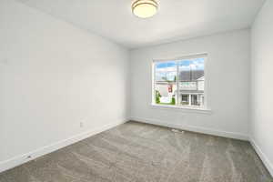 Empty room with carpet flooring and baseboards