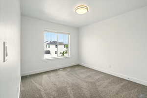Empty room with carpet floors and baseboards