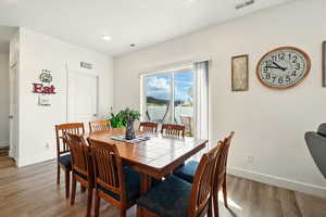 Dining space featuring baseboards, wood finished floors, and recessed lighting