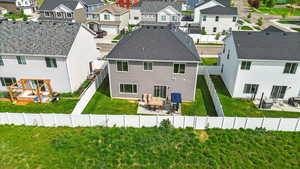 Rear view of property featuring a residential view, a patio, and a shingled roof
