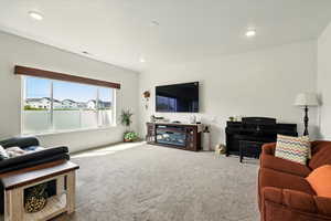 Living area with carpet and recessed lighting