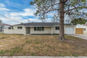 Ranch-style house featuring a garage, concrete driveway, brick siding, and a shingled roof