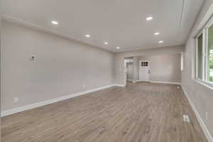 Empty room featuring light wood-type flooring, recessed lighting, and baseboards