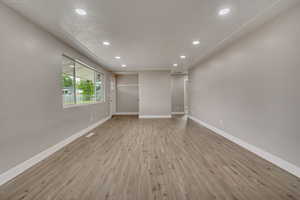 Unfurnished room with recessed lighting, light wood-type flooring, and baseboards