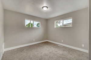 Unfurnished room featuring carpet floors and baseboards