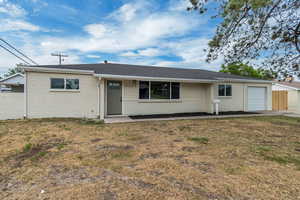 Ranch-style home with a garage, brick siding, a porch, a front lawn, and roof with shingles