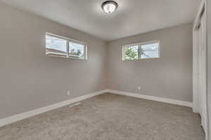 Unfurnished bedroom featuring carpet, baseboards, and a closet