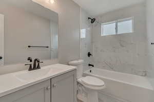 Bathroom with vanity, toilet, and tub / shower combination
