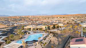Aerial perspective of suburban area with a mountain backdrop and a pool area