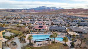 Aerial perspective of suburban area with a pool area and mountains