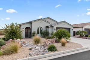 Mediterranean / spanish-style house featuring a garage, stucco siding, concrete driveway, and a tile roof