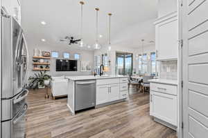 Kitchen featuring stainless steel appliances, a sink, recessed lighting, light wood-type flooring, and a ceiling fan