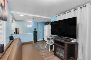 Living area featuring baseboards and wood finished floors