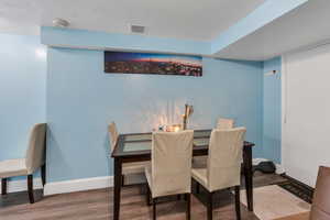 Dining room featuring wood finished floors and baseboards