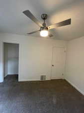 Unfurnished bedroom with baseboards, carpet floors, and ceiling fan