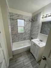Full bath featuring vanity and shower / bath combination