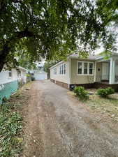View of front of house featuring driveway and covered porch