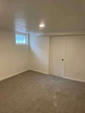 Basement featuring carpet and baseboards