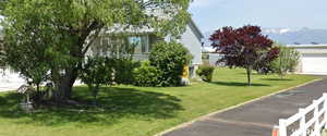 View of grassy yard featuring a garage