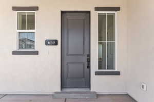 Property entrance with stucco siding