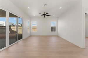 Unfurnished room with light wood-type flooring, ceiling fan, recessed lighting, and baseboards