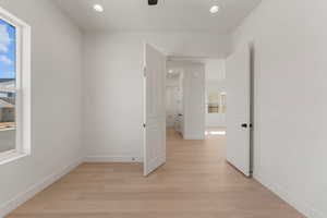 Empty room with light wood-style flooring, recessed lighting, baseboards, and a ceiling fan