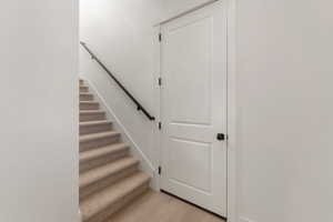 Stairs featuring wood finished floors