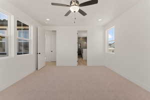 Unfurnished bedroom featuring light carpet, recessed lighting, baseboards, and ceiling fan