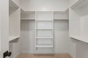 Walk in closet with carpet floors