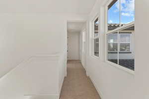 Corridor with carpet floors and baseboards