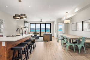 Dining area featuring light wood finished floors, a chandelier, and recessed lighting