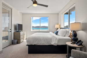Bedroom with carpet, a ceiling fan, and access to exterior