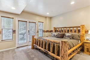 Carpeted bedroom with access to exterior, recessed lighting, and baseboards