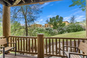 Wooden terrace featuring a lawn