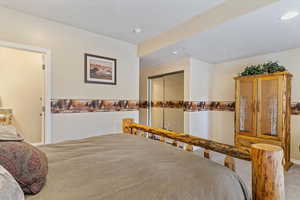 Bedroom with carpet, a closet, and recessed lighting